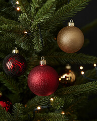 Fototapeta premium Christmas ornaments hanging on pine tree branches