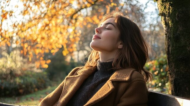 A woman sitting on a bench in the park, leaning back with her eyes closed, soaking up the sunshine.