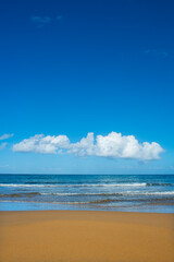Cyprus Alagadi Turtle Beach. View from the beach to the sea. Magnificent beach, sea and blue cloudy sky. Yellow sand beach. Beach and blue sky.