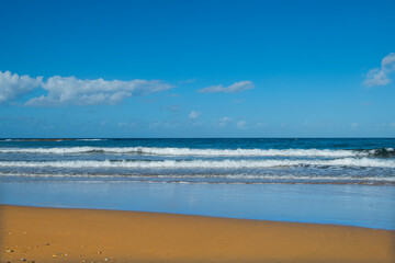 Cyprus Alagadi Turtle Beach. View from the beach to the sea. Magnificent beach, sea and blue cloudy sky. Yellow sand beach. Beach and blue sky.