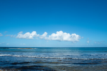 Cyprus Alagadi Turtle Beach. View from the beach to the sea. Magnificent beach, sea and blue cloudy sky. Yellow sand beach. Beach and blue sky.