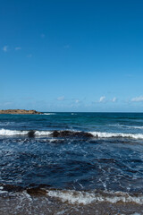 Cyprus Alagadi Turtle Beach. View from the beach to the sea. Magnificent beach, sea and blue cloudy sky. Yellow sand beach. Beach and blue sky.