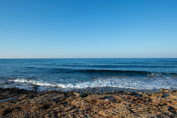 Cyprus Alagadi Turtle Beach. View from the beach to the sea. Magnificent beach, sea and blue cloudy sky. Yellow sand beach. Beach and blue sky.