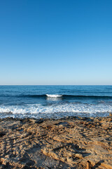 Cyprus Alagadi Turtle Beach. View from the beach to the sea. Magnificent beach, sea and blue cloudy sky. Yellow sand beach. Beach and blue sky.