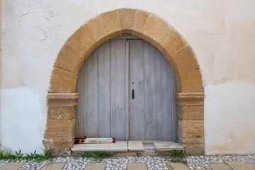 Old historical colorful doors and shutters made of wrought iron and wood. Old historical wooden doors in Cyprus. Doors and shutters of historical stone houses in Nicosia.	