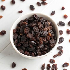 Fototapeta premium Top View of Raisins in a Bowl on a White Background