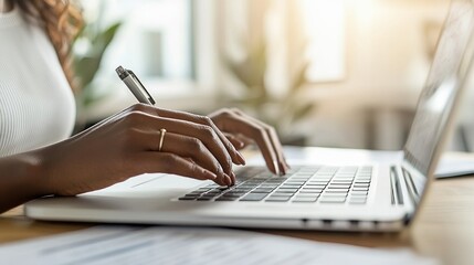 Woman typing laptop, office, paperwork, sunlight, work