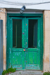 Old historical colorful doors and shutters made of wrought iron and wood. Old historical wooden doors in Cyprus. Doors and shutters of historical stone houses in Nicosia.	