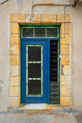 Old historical colorful doors and shutters made of wrought iron and wood. Old historical wooden doors in Cyprus. Doors and shutters of historical stone houses in Nicosia.	