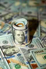 Money rolls and cash scattered on a surface create a wealth display
