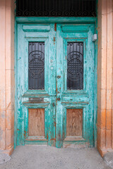 Old historical colorful doors and shutters made of wrought iron and wood. Old historical wooden doors in Cyprus. Doors and shutters of historical stone houses in Nicosia.	