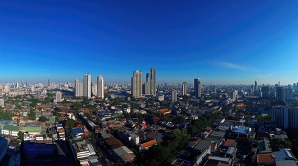 Naklejka premium Panoramic Cityscape View of Urban Skyline Under Bright Blue Sky