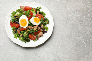 Delicious fresh tuna salad on grey textured table, top view. Space for text