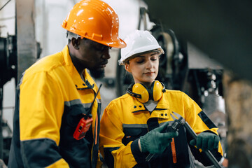 professional engineer team checking product quality control in metal workshop production line