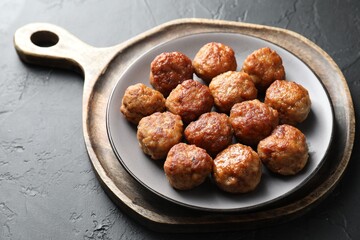 Tasty cooked meatballs on grey table, closeup