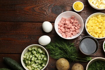 Different ingredients for okroshka soup on wooden table, flat lay. Space for text