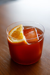 Cup of creation coffee Mocktail drink decorated with orange on wooden table.