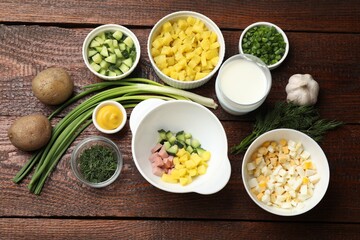 Ingredients for okroshka soup on wooden table, flat lay