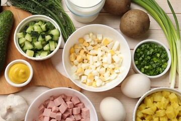 Fresh ingredients for okroshka soup on light wooden table, flat lay