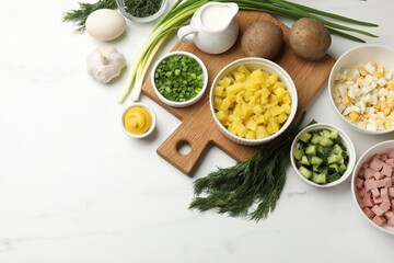 Ingredients for okroshka soup on white marble table, flat lay. Space for text