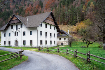 Amazing autumn view with beautiful mountain house along the road and colorful autumn trees at background in the picturesque Logar Valley (Logarska Dolina) and Solcava panoramic road, Slovenia © Jess_Ivanova