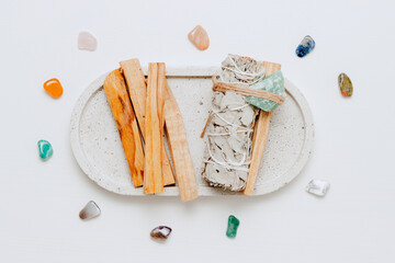 Incense set for fumigation of premises. Palo santo, white sage on the tray with gemstones. Spiritual practice for mindset, stress relief, healing and meditation