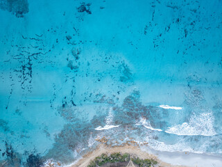 Aerial view of shallow turquoise ocean water with seafloor underneath. Overhead view of mediterran sea.