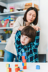Cute preschool child is engaged in speech therapist office and correcting his speech