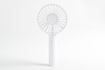 Mini electric white fan with handle isolated on white background.
