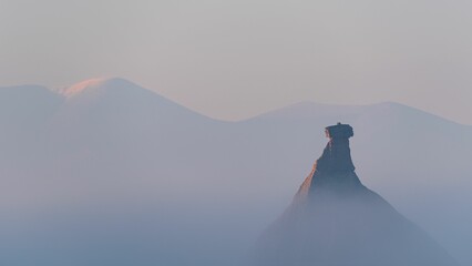 Mystical landscape of Castil de Tierra with Moncayo mountains in the mist, Bardenas Reales, Spain