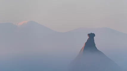 Selbstklebende Fototapeten Dunkelgrau Mystical landscape of Castil de Tierra with Moncayo mountains in the mist, Bardenas Reales, Spain  © Wirestock