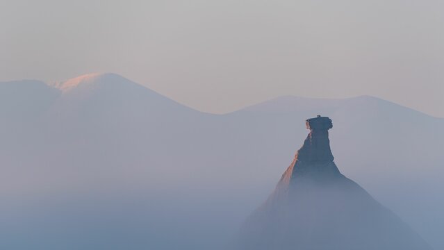 Mystical landscape of Castil de Tierra with Moncayo mountains in the mist, Bardenas Reales, Spain