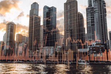 Fototapeta premium Financial graph showing growth over cityscape at sunset representing economic success