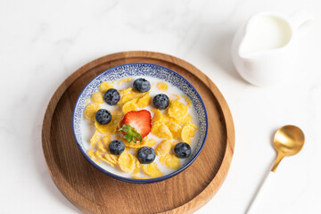 cornflakes  in a bowl on a light background, breakfast