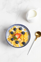 cornflakes  in a bowl on a light background, breakfast