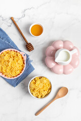 cornflakes  in a bowl on a light background, breakfast