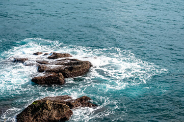 Wave splashing on the rocks near the coastline, in Keelung city, Taiwan.