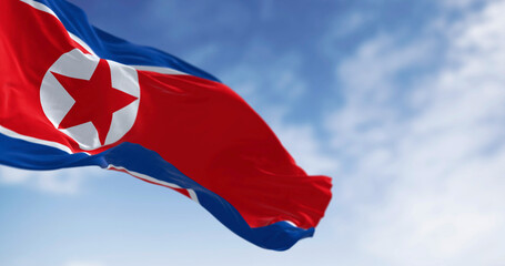 Naklejka premium Close-up of North Korea national flag waving in the wind on a clear day