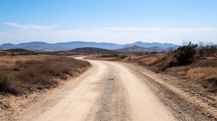 Fototapeta premium Dusty Road Leading Through Barren Countryside Under Clear Blue Sky for Adventurous Journeys : Generative AI