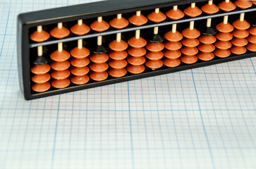Abacus for mental arithmetic on light blue checkered background. space for text