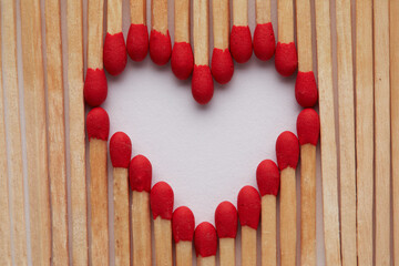 Close-up of heart made of match sticks on white background - Love concept