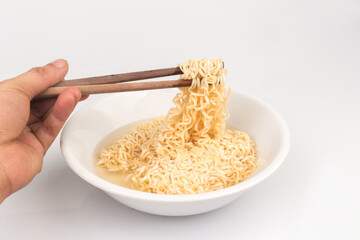 Instant noodles on a plate and chopsticks spoon isolated on white background