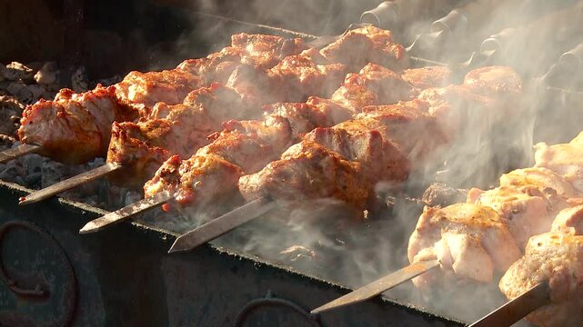 shish kebab on skewers is grilled on a sunny day