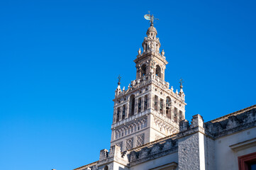 Fototapeta premium Walking in old historical Andalusian town Seville, Cathedral church, Spain. View on houses, streets, architectural details of buidings. Summer in Andalusia.