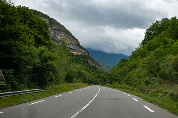 Driving car or camper on free road Route Napoleon in French Alps, touristic road in France