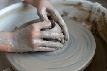 Making of mud pot on potters wheel during workshop in art ceramic atelier in Poland