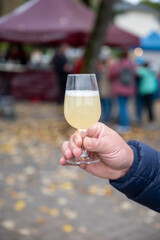 Autumn wine festival in Schengen, Luxembourg, tasting of fiederwaissen young wine fermented freshly pessed auxerrois grape juice, or must