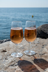 Drinking rose champagne or cava sparkling wine in  Puerto Banus in Marbella, Spain. Sandy beaches, luxury yacht harbour in Costa del Sol, Andalusia.