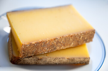 French cheese Comte, varieties unpasteurised ed milk Prestige, fruity flavoured Fruite and Vieille Reserve close up