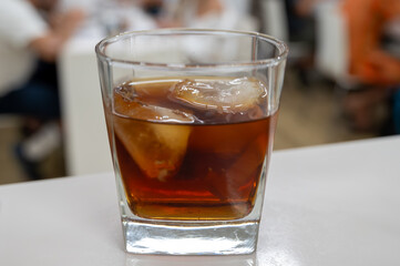 Tasting Sherry sweat cream wine on ice rocks, jerez fortified wine made from palomino white grape served in Jerez de la Frontera, Cadiz, Andalusia, Spain